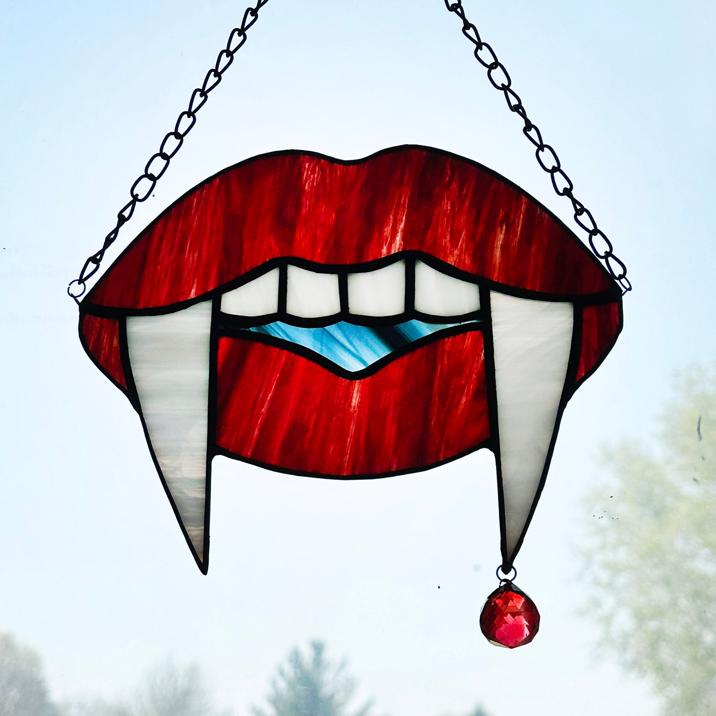Red Marble Vampire Teeth Suncatcher