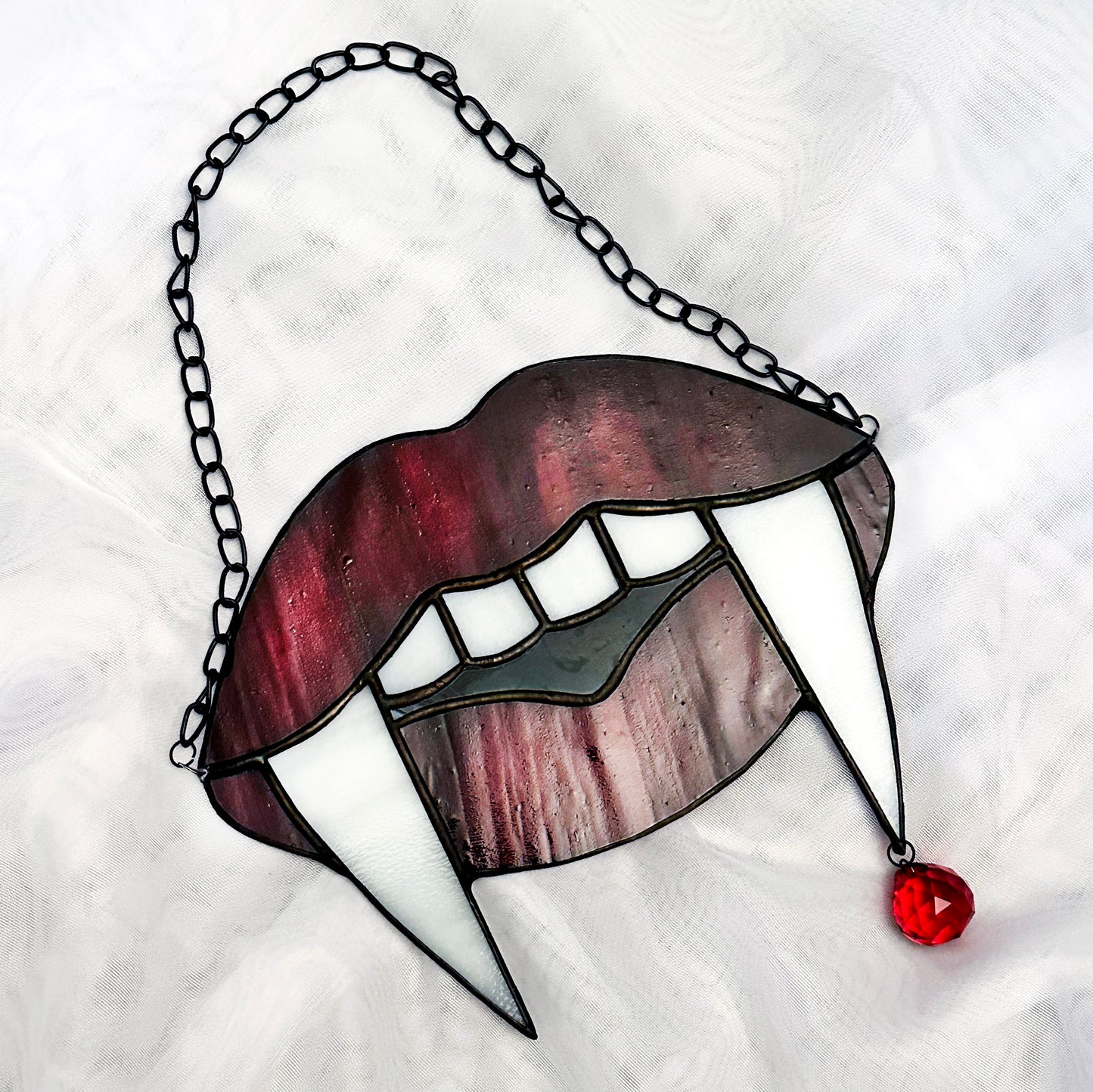 Red Marble Vampire Teeth Suncatcher
